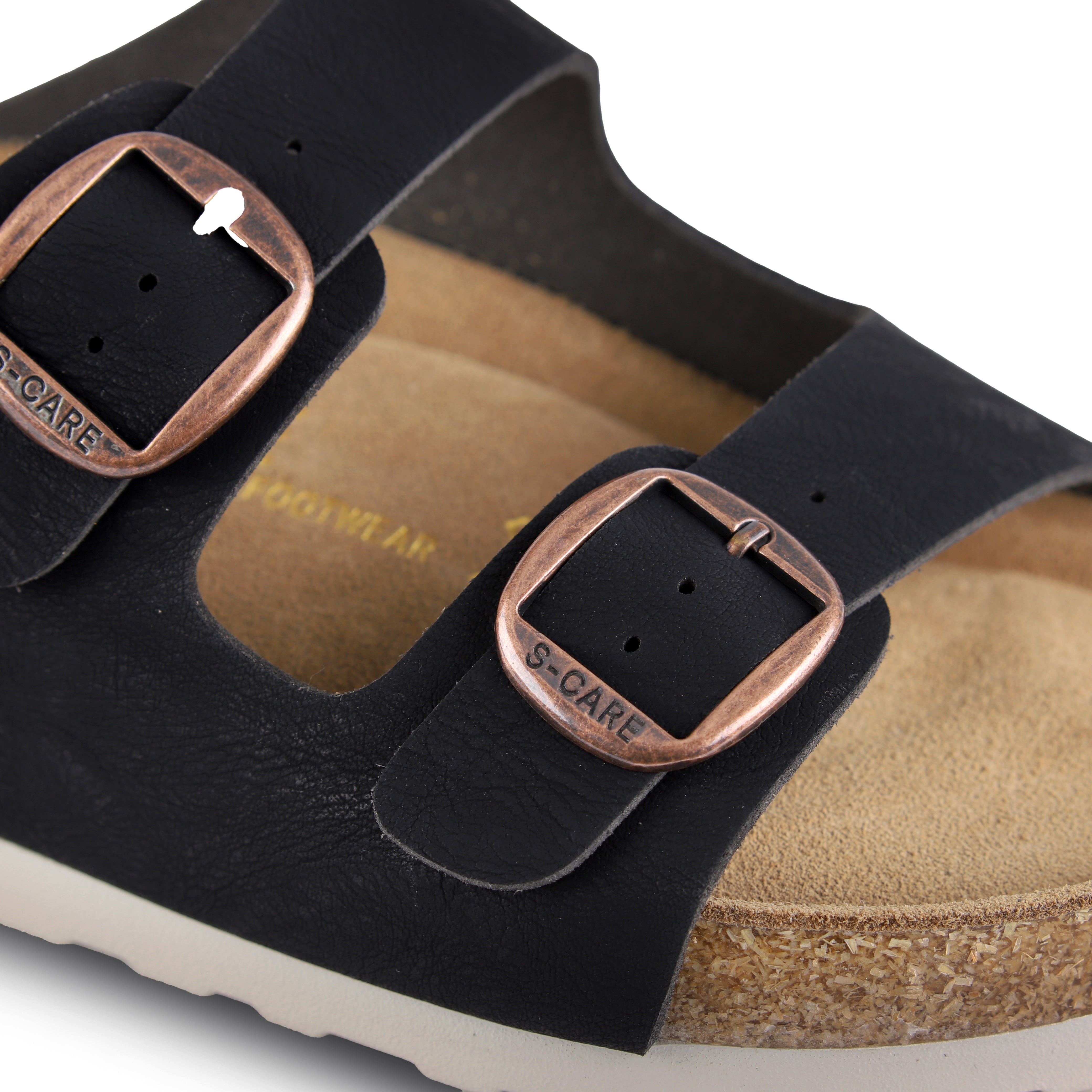 Close-up of S-CARE Bali Sandals in black, capturing the texture of the strap, stitching, and footbed cushion.
