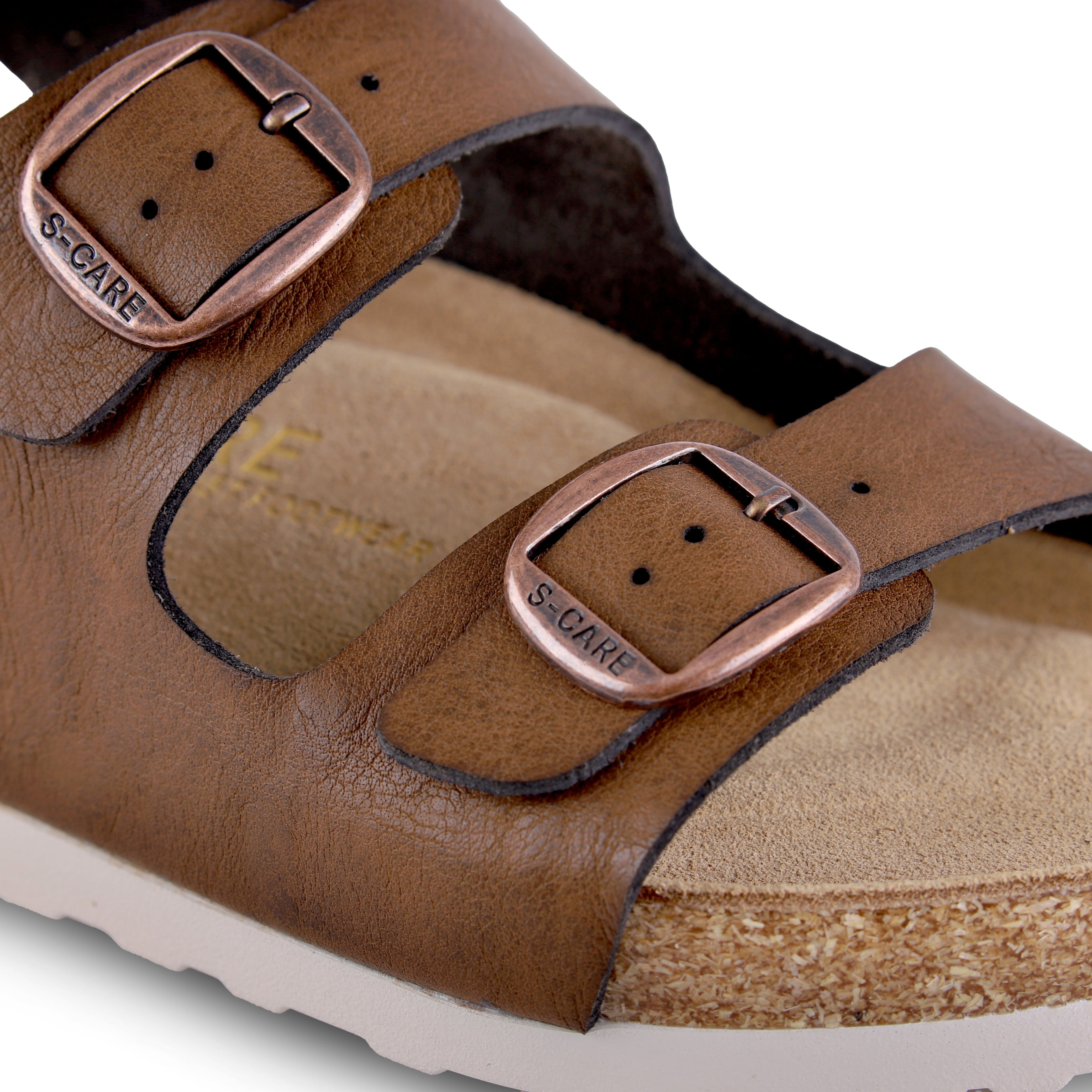 Close-up of S-CARE Bali Sandals in brown, focusing on the texture of the straps, stitching details, and footbed cushion.